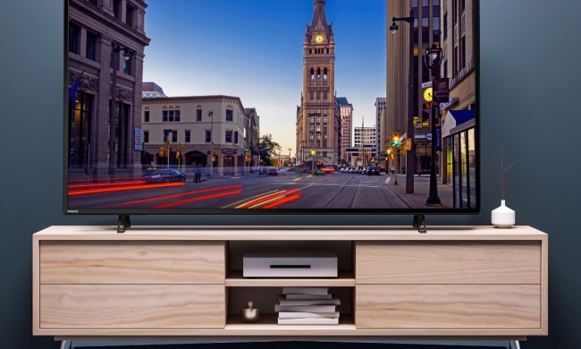 The 65-inch Philips 4K TV with a city scene on the screen.