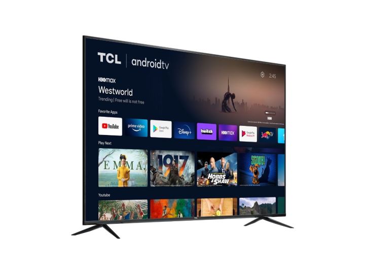 TCL 70-inch 4K TV on White Background at a side-angle while displaying apps and show recommendations.