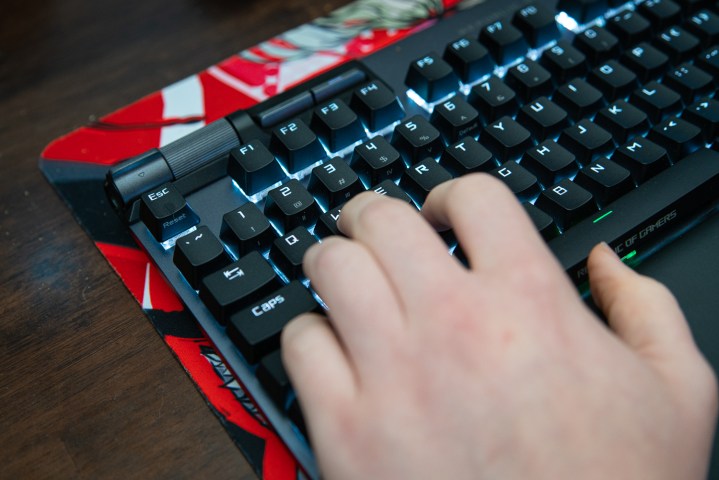 Fingers on WASD on a gaming keyboard.