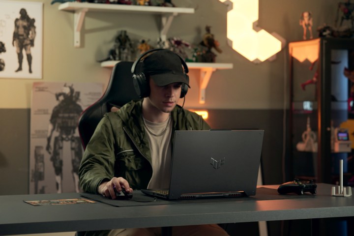 A person using the Asus TUF F15 gaming laptop.