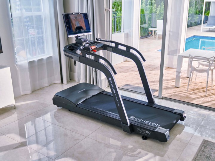 Echelon Stride-5s treadmill in a room with a pool in the background.