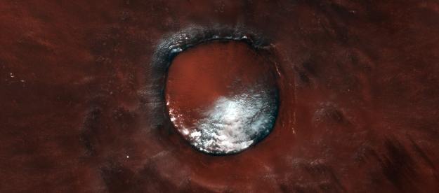 Like a sprinkle of powdered sugar on a rich red velvet cake, this scene from the ESA/Roscosmos ExoMars Trace Gas Orbiter captures the contrasting colours of bright white water-ice against the rusty red martian soil.