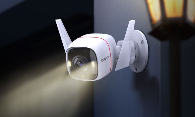 Tapo C320WS security camera mounted outdoors with lights on.