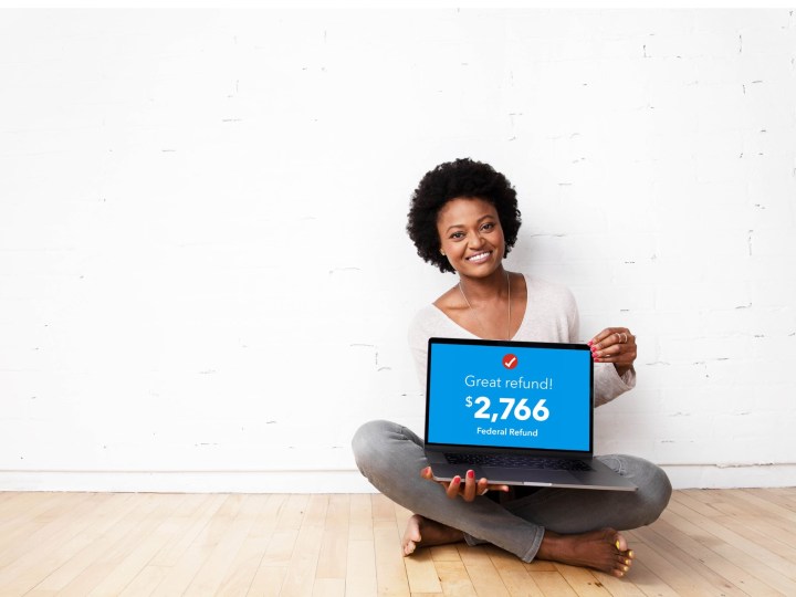 Woman showing her tax return done with TurboTax Live service.