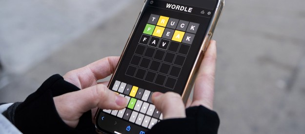 A person plays 'Wordle' on an iPhone.