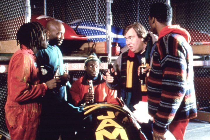 John Candy talks to his team around a bobsled in Cool Runnings.
