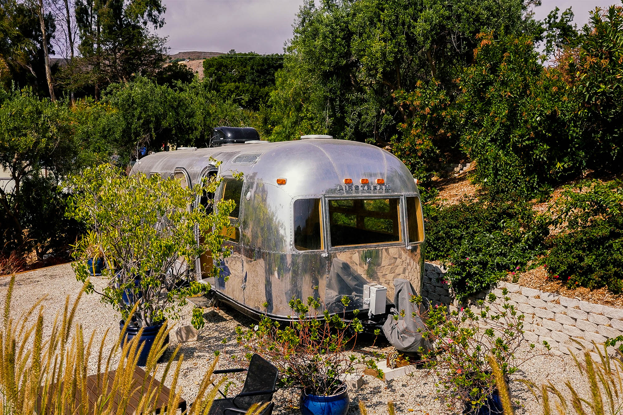 An airstream sits tucked away on the property.