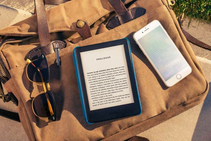 A Kindle placed next to a smartphone.
