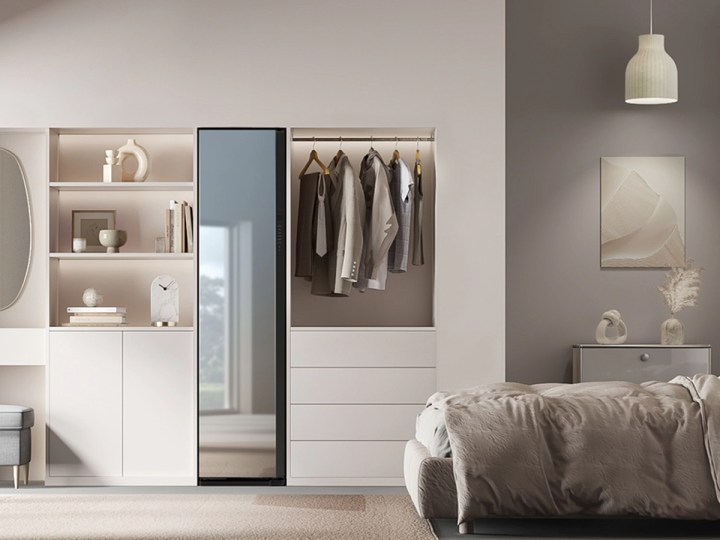 A Samsung Bespoke AirDresser Clothing Care System with Steam Refresh in mirror finish in a bedroom setting.