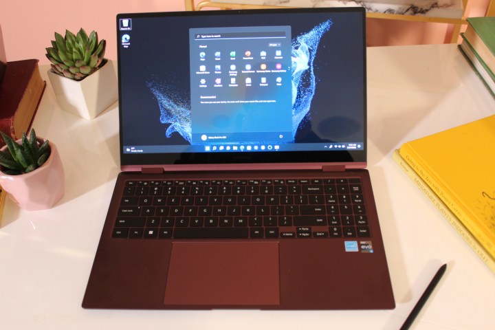 Samsung Galaxy Book 2 Pro with desktop displayed on his desk.