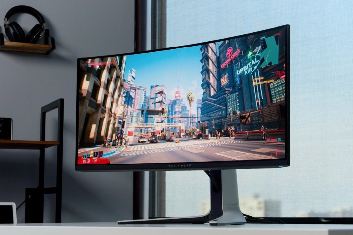 The Alienware QD-OLED monitor in front of a window.