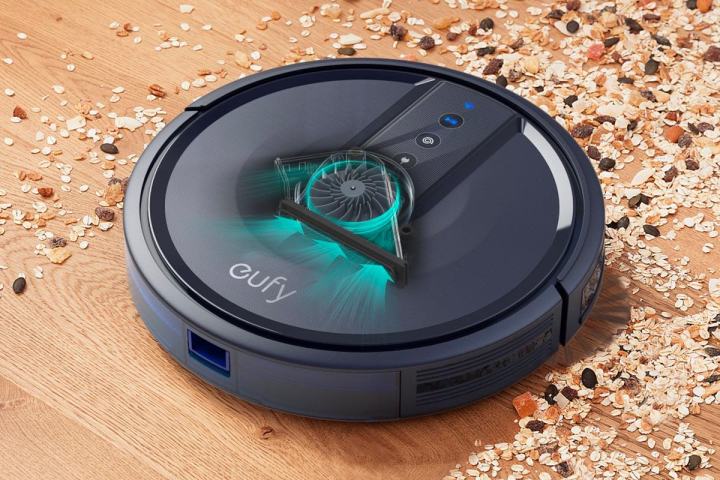 Anker Eufy 25C Robot Vacuum placed on a carpet while lit up.