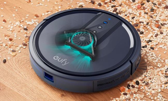 Anker Eufy 25C Robot Vacuum placed on a carpet while lit up.
