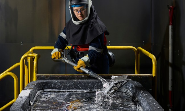 Woman mixing smelting aluminum.