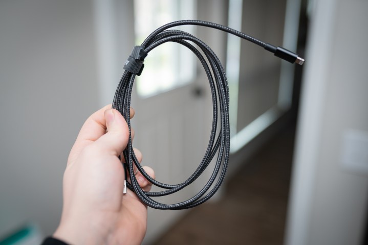 Someone holding a wrapped cable.