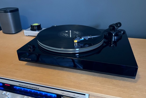 The Fluance RT85N turntable in piano black on a media unit.