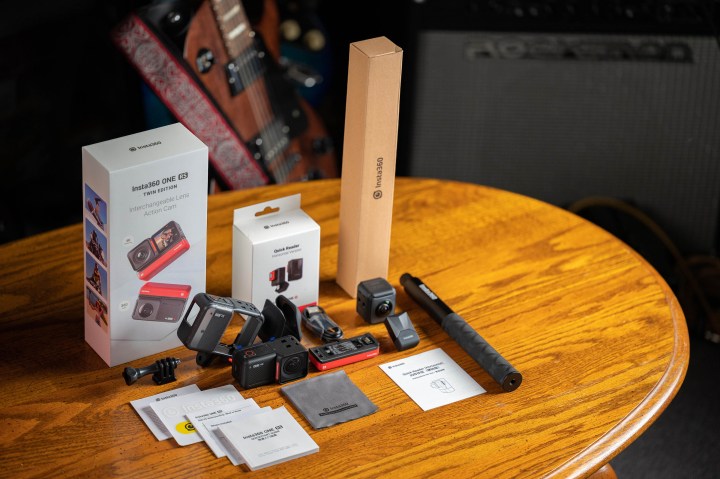 Insta360 One RS with accessories and packaging on a table.
