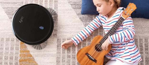 Little girl with guitar sleeping on a rug while eufy by Anker BoostIQ RoboVac 11S (Slim) Robot Vacuum Cleaner vacuums.