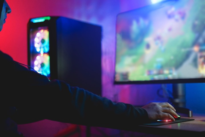 A player plays on a PC setup.