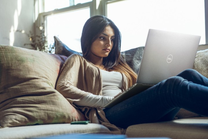 Woman on couch with XPS 17 on her lap.