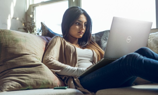 Woman on couch with XPS 17 on her lap.