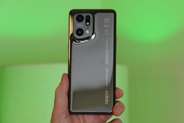 Oppo Find X5 Pro held in hand seen from the back.