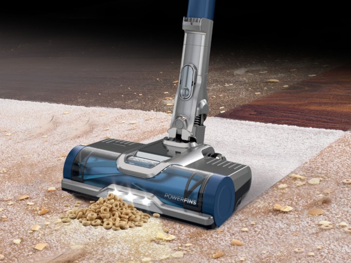 Shark Cordless Pet Plus with Anti-Allergen Complete Seal vacuuming cereal and debris from hardwood and carpet.