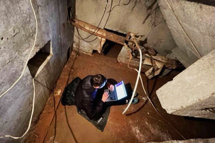 A Ukrainian IT worker sits on his laptop in a basement as Russian continues to attack Ukraine.