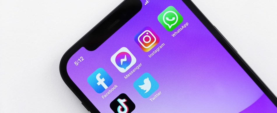 A series of social media app icons on a colorful smartphone screen.