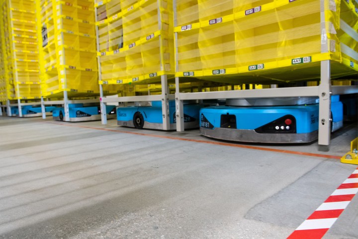 Amazon logistics robots move pallets around in the an Amazon fulfillment center.