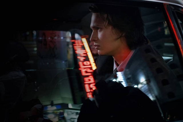 Ansel Elgort rides in a car in a scene from Tokyo Vice.