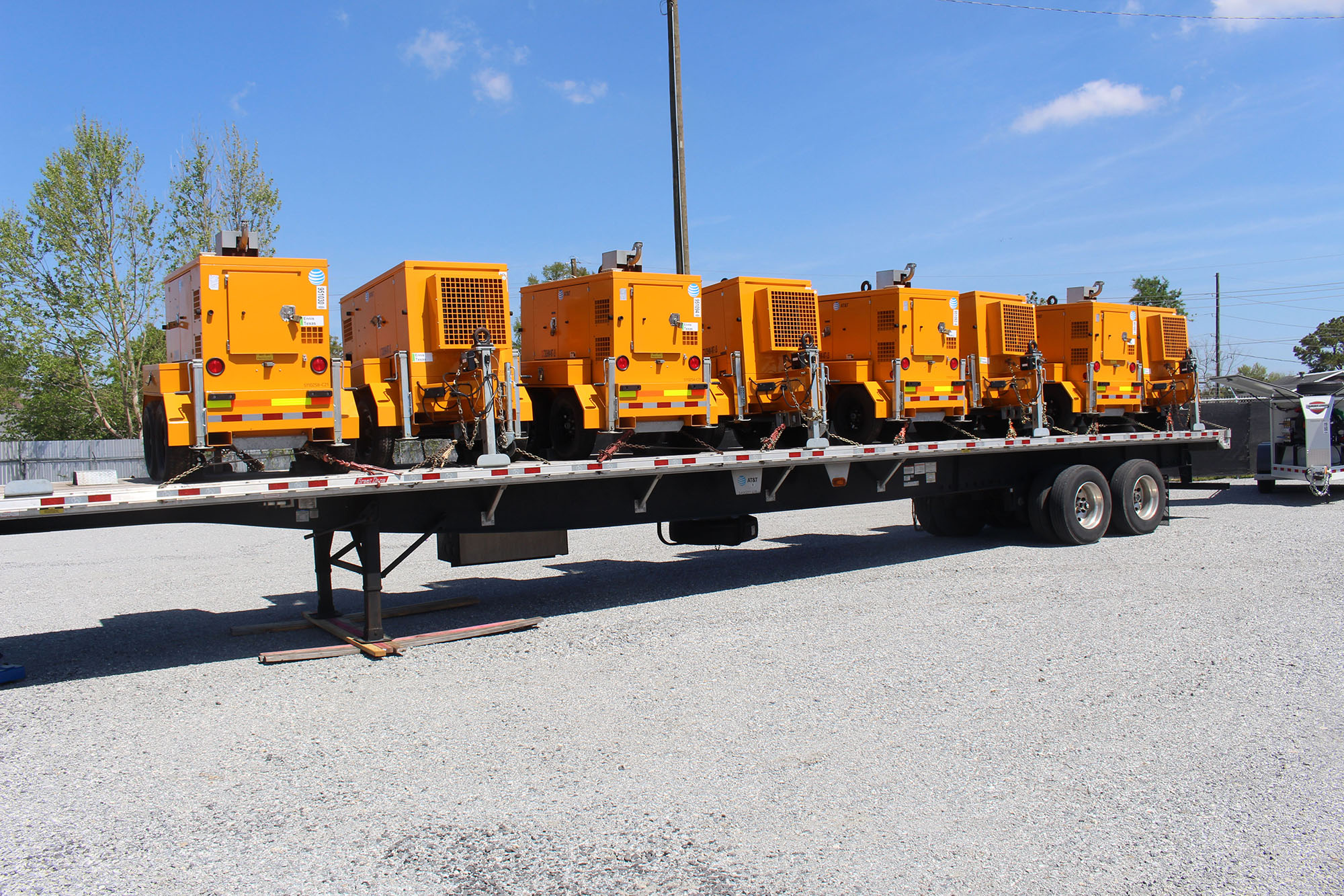 Power generators loaded onto a flatbed trailer.