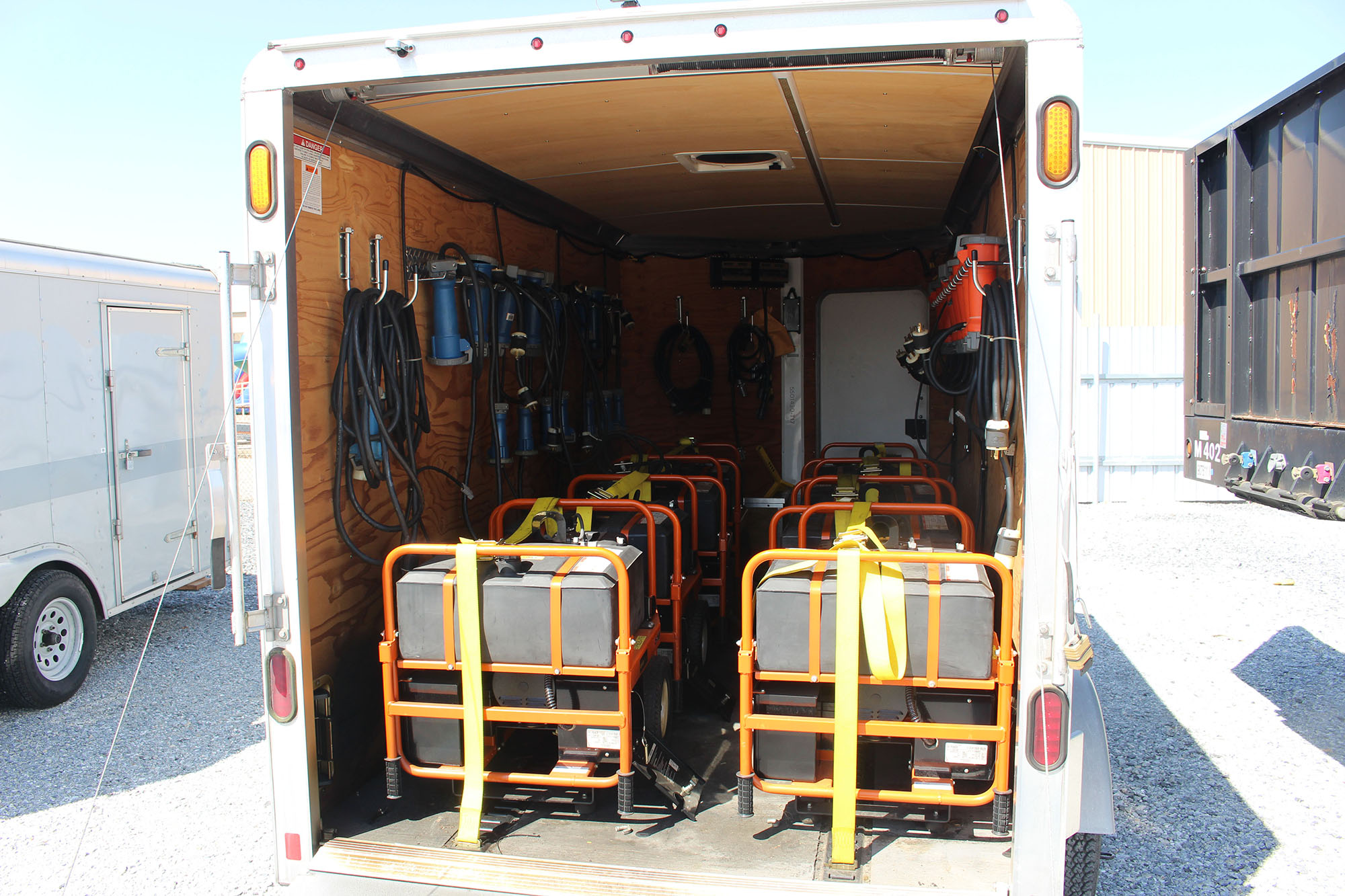 Toolboxes and tools loaded into a trailer.