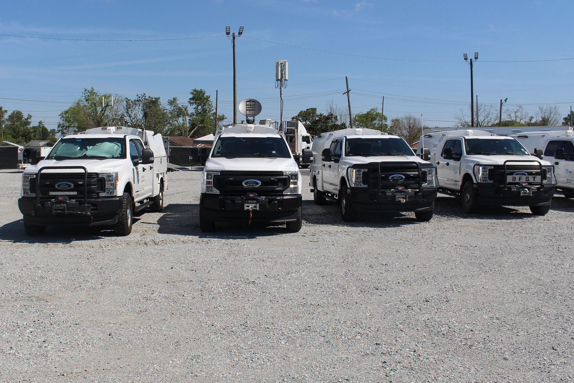 A line of AT&T disaster recovery trucks.