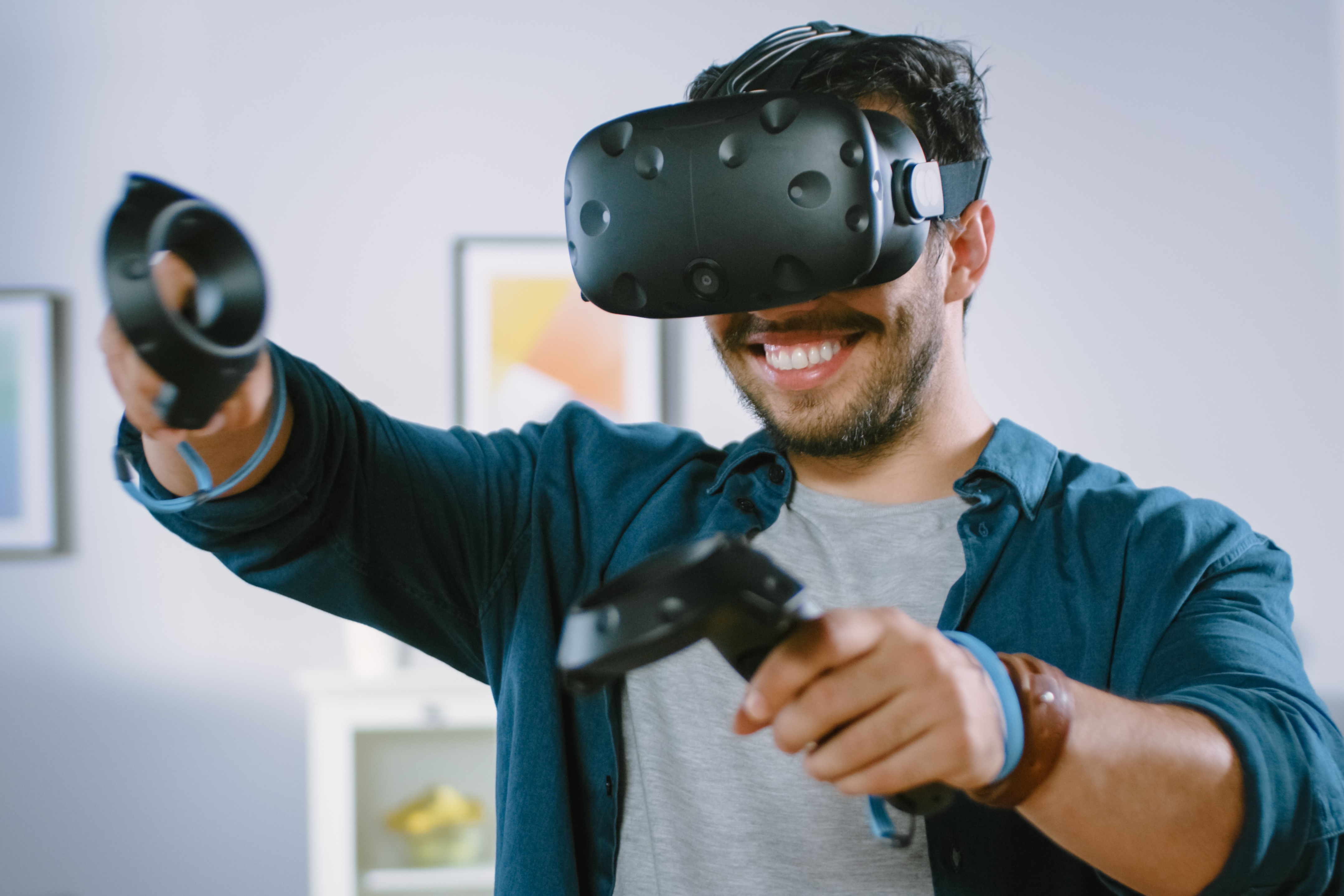 A man uses a VR headset while playing a game.