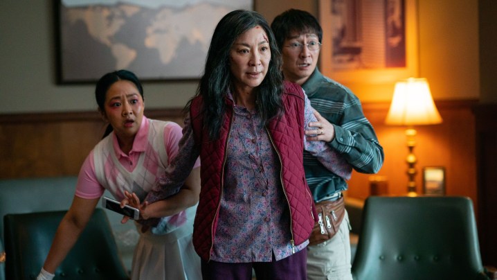Michelle Yeoh stands in front of her character's husband and daughter in a scene from Everything Everywhere All At Once.