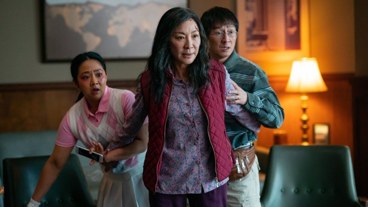 Michelle Yeoh stands in front of her character's husband and daughter in a scene from Everything Everywhere All At Once.