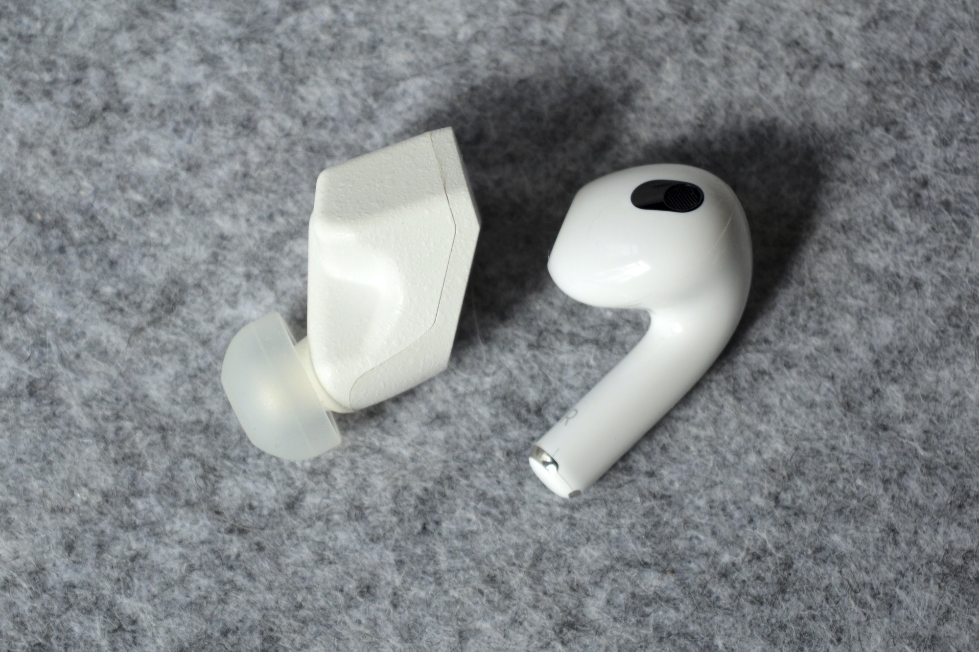 Final Audio ZE3000 wireless earbuds seen next to the third-gen Apple AirPods.