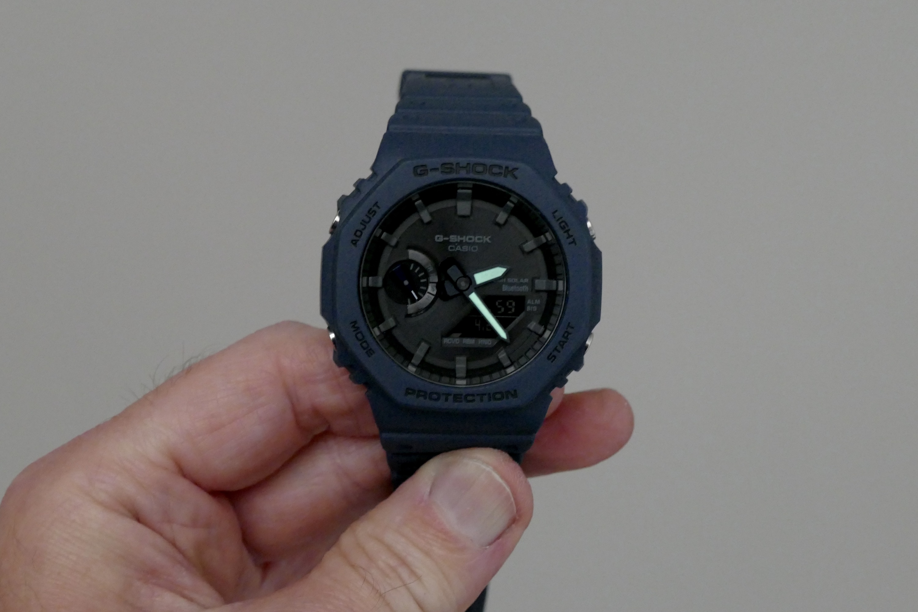 Lowlight photo showing the G-Shock GA-B2100 lume on its hour and minute hands.