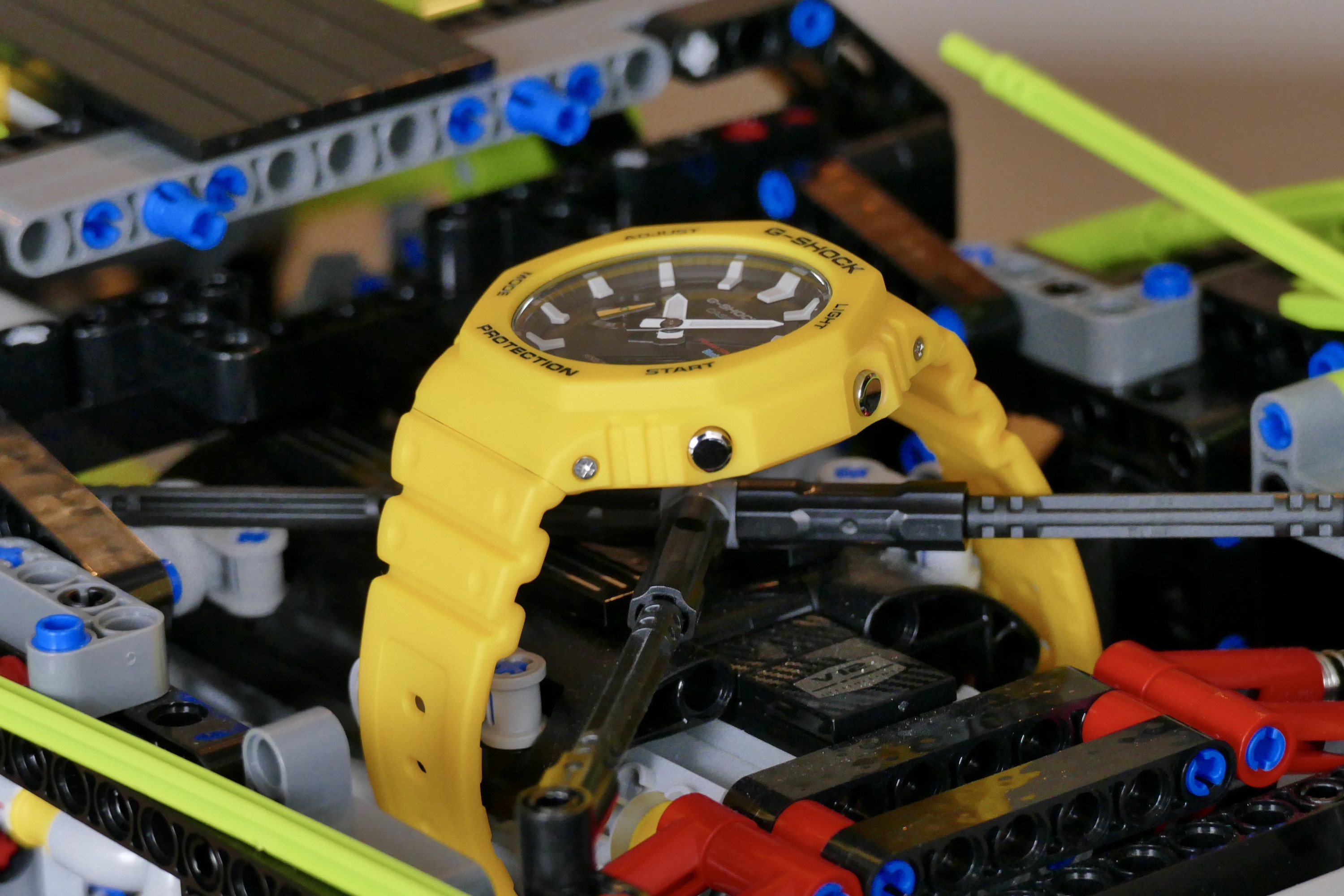 Side view showing the buttons on a yellow G-Shock GA-B2100.