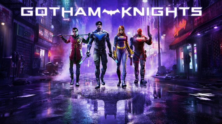 The four heroes of Gotham Knights walk in a purple street under the game title text.