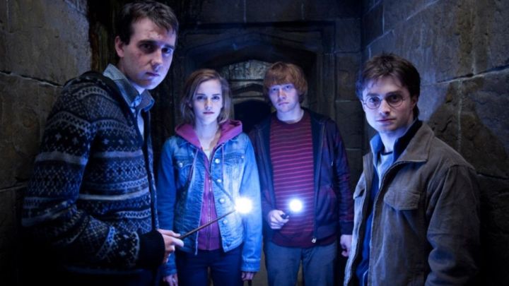 Neville, Hermione, Ron, and Harry inside a dark tunnel in HP and the Deathyl Hallows Part 2