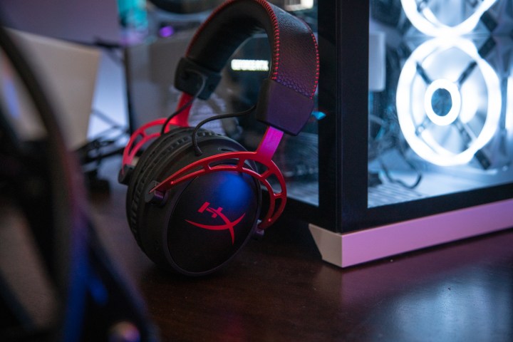 HyperX Cloud Alpha Wireless headset leaning against a gaming PC.