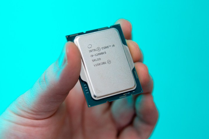 A hand holds the Intel Core i9-12900KS.