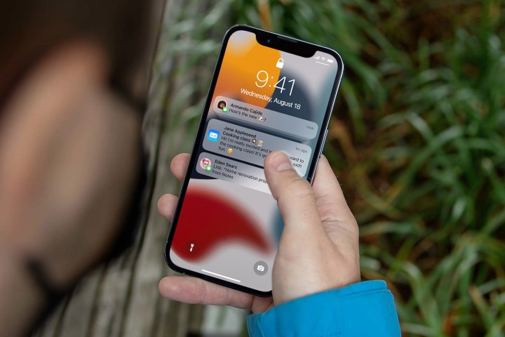 Man looking at notifications on his iPhone 12.