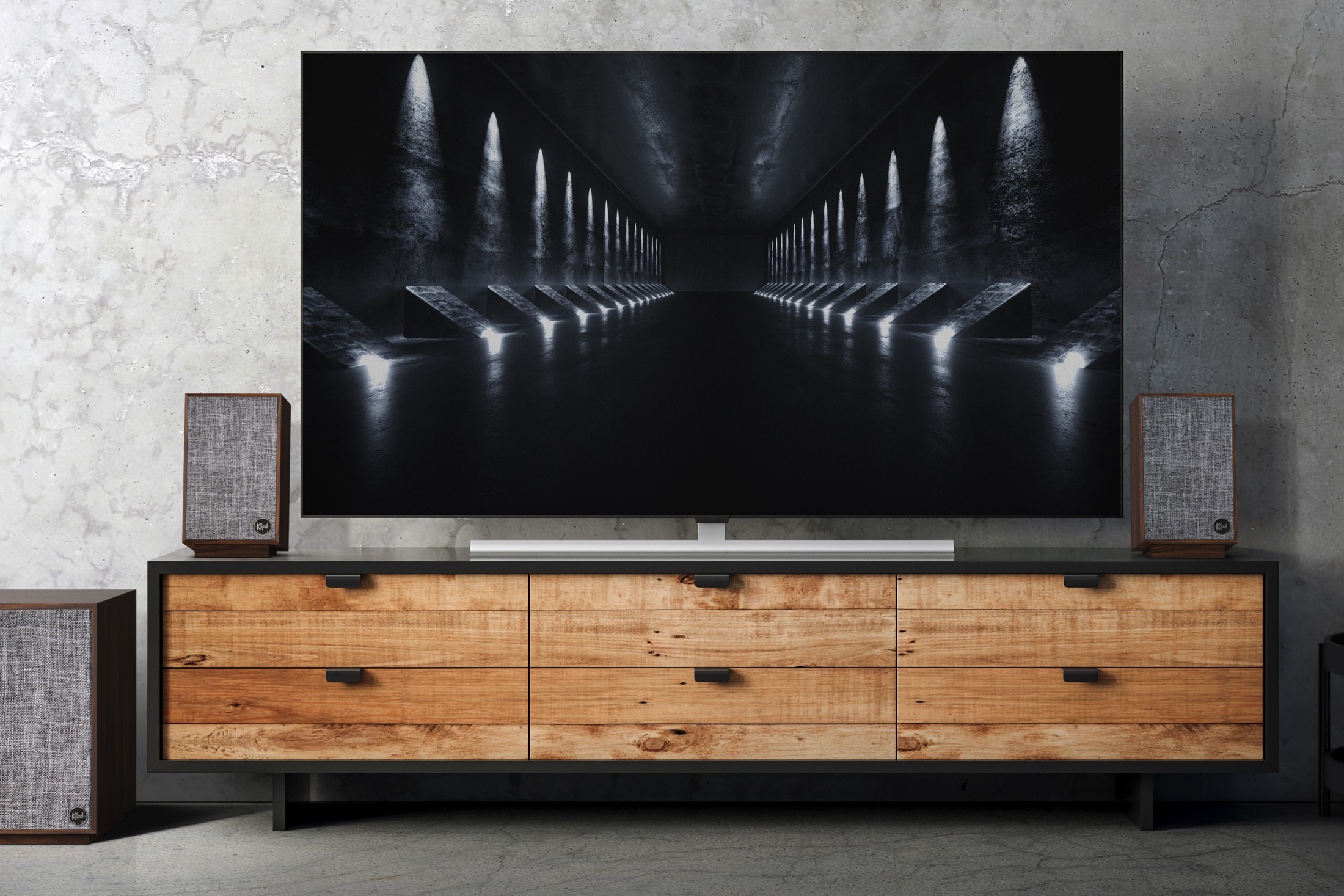 Klipsch ProMedia 2.1 speaker system seen next to a flat-screen TV.