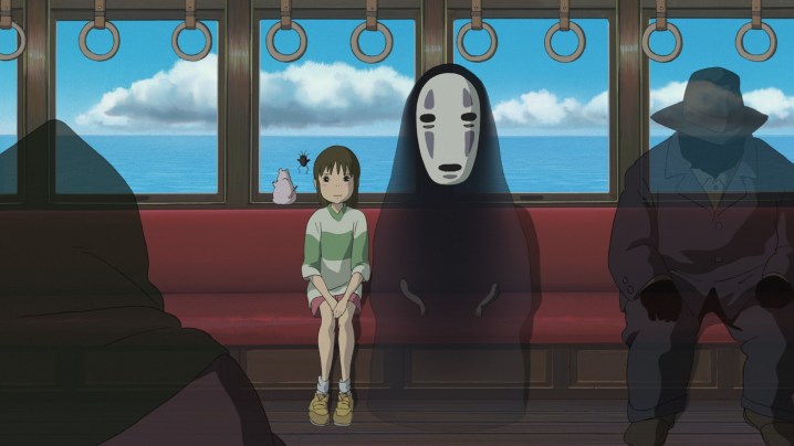 Chihiro assis avec No-Face dans Spirited Away.