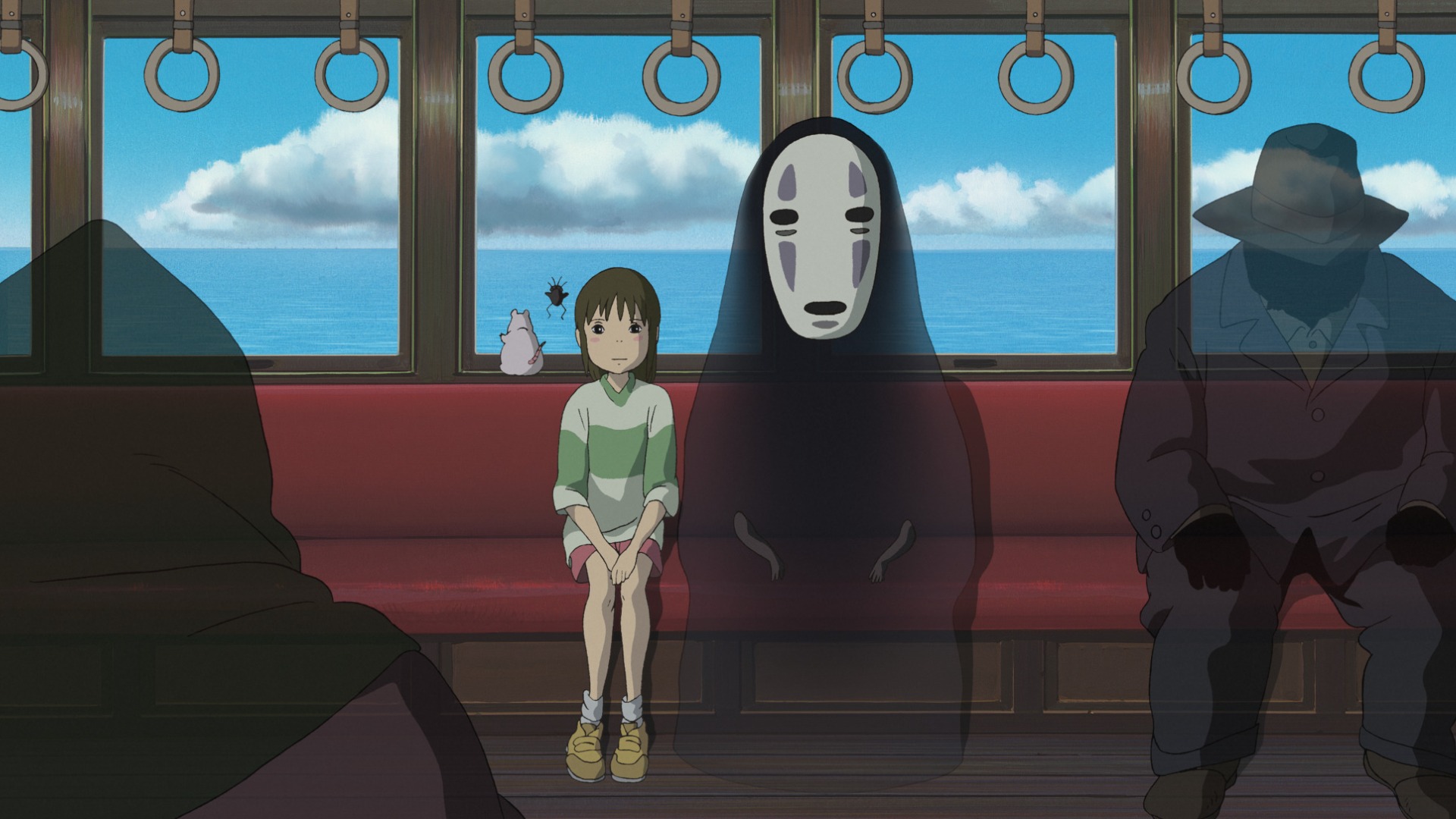 Chihiro sitting with No-Face in Spirited Away.