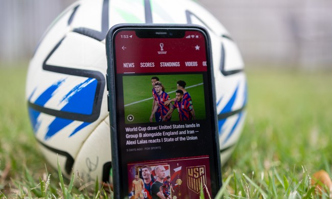 Fox Sports app on an iPhone in front of a soccer ball.