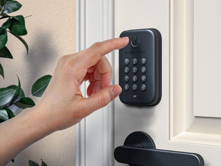 Person using the Wyze Lock Bolt finger scanner to open the door.